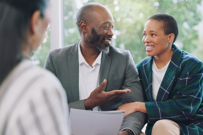 A couple sits on a couch discussing their audit review with a Siepert accountant