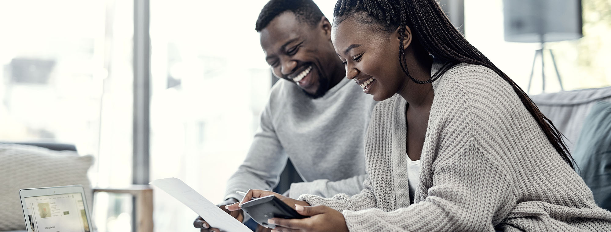 Couple going through finances together on computer at home