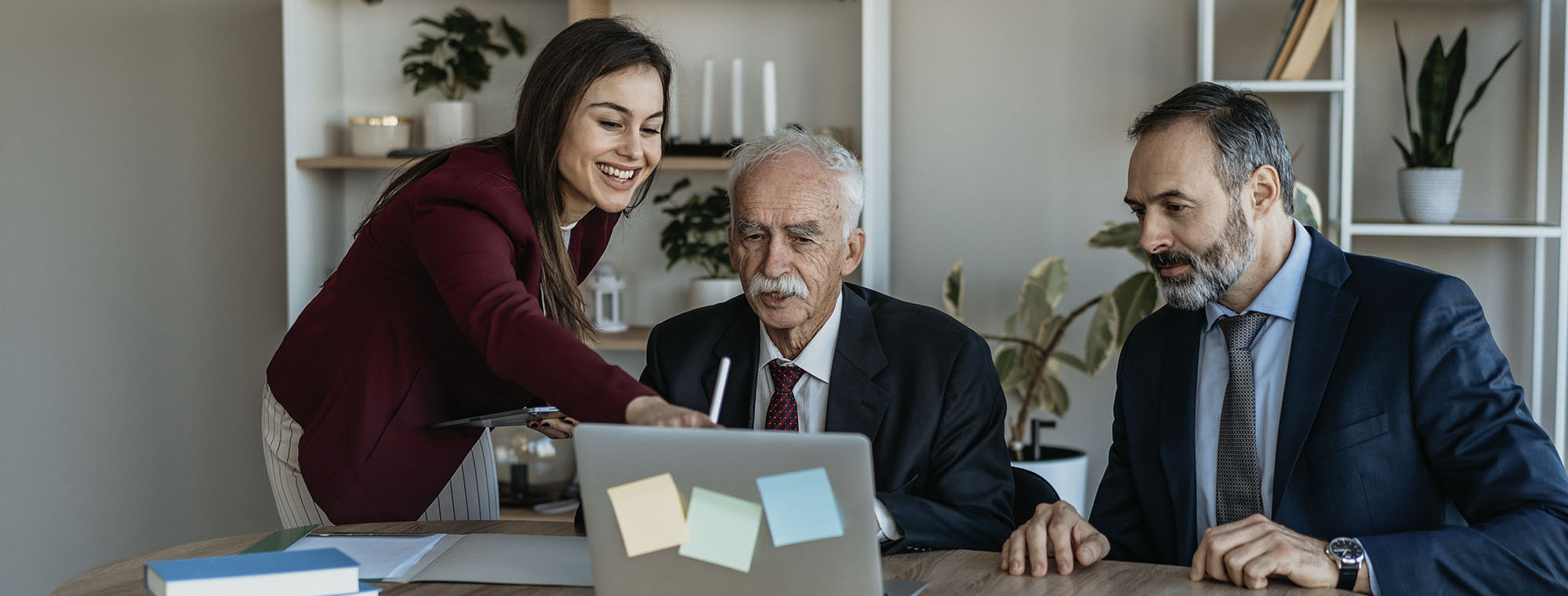 Older owner discussing business plans with younger succeeding partners